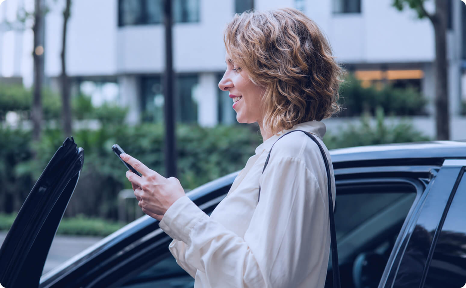 Driver using the Spark Connect app next to her EV